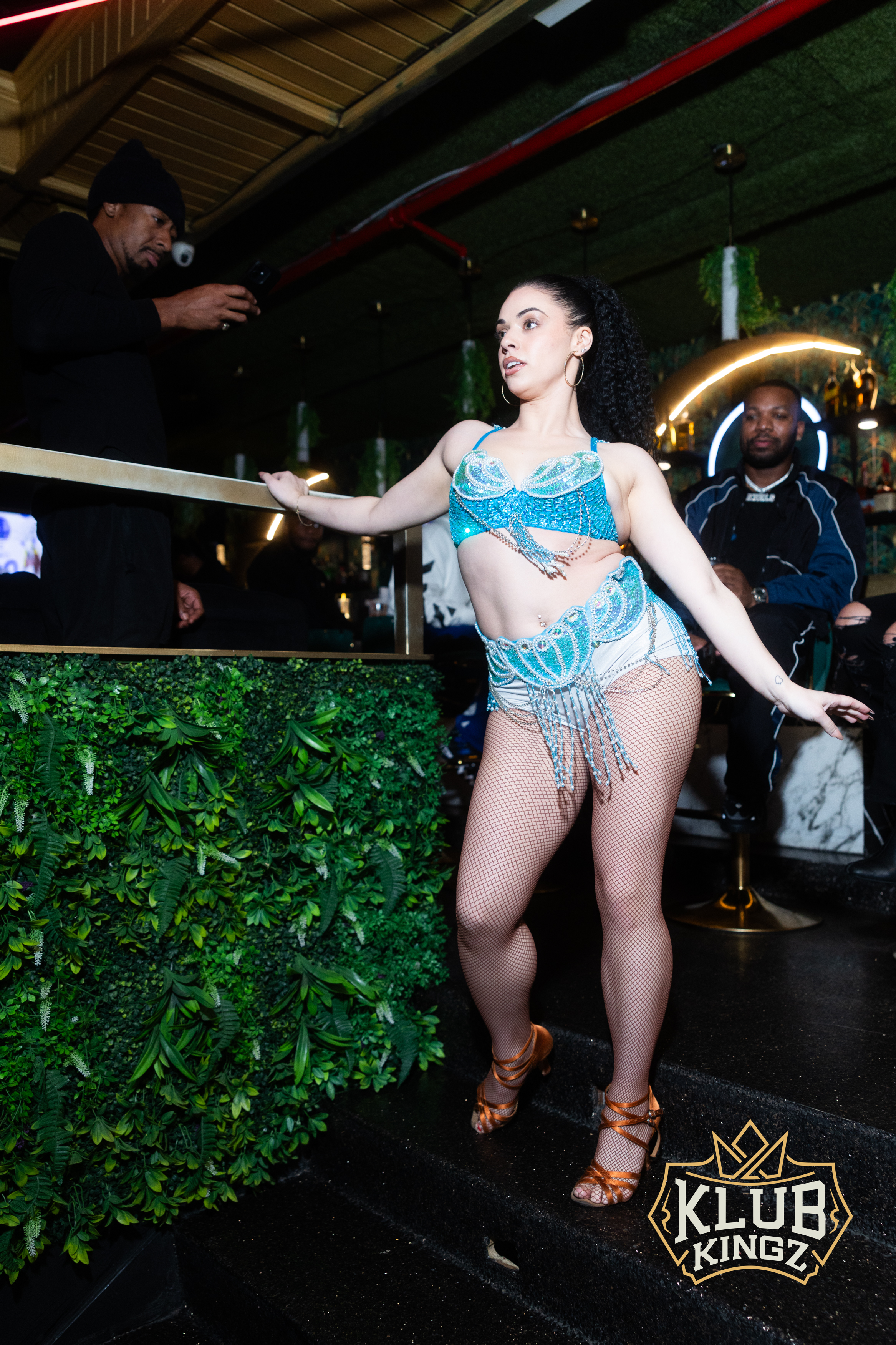 Dancer in sparkling blue costume performing on stage at Klub Kingz nightclub event