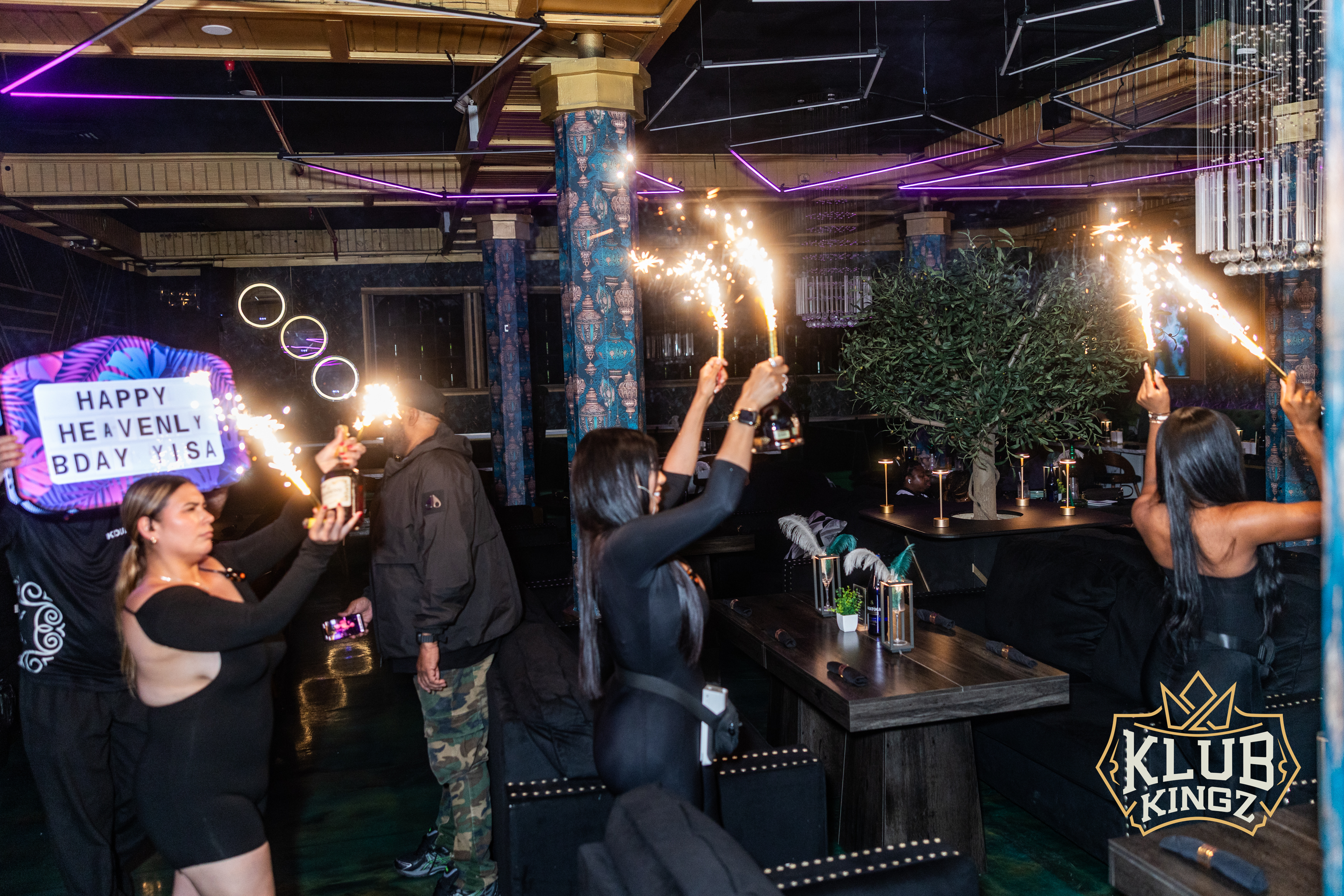 Guests hold sparkler bottle service celebrating a birthday party at Klub Kingz nightclub