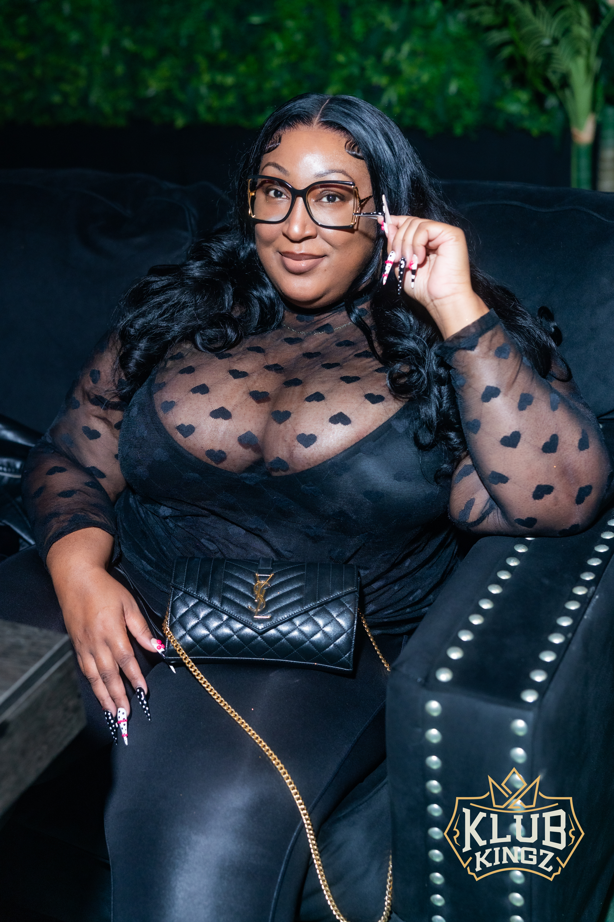 Stylish guest in heart-print sheer top posing at Klub Kingz nightlife event
