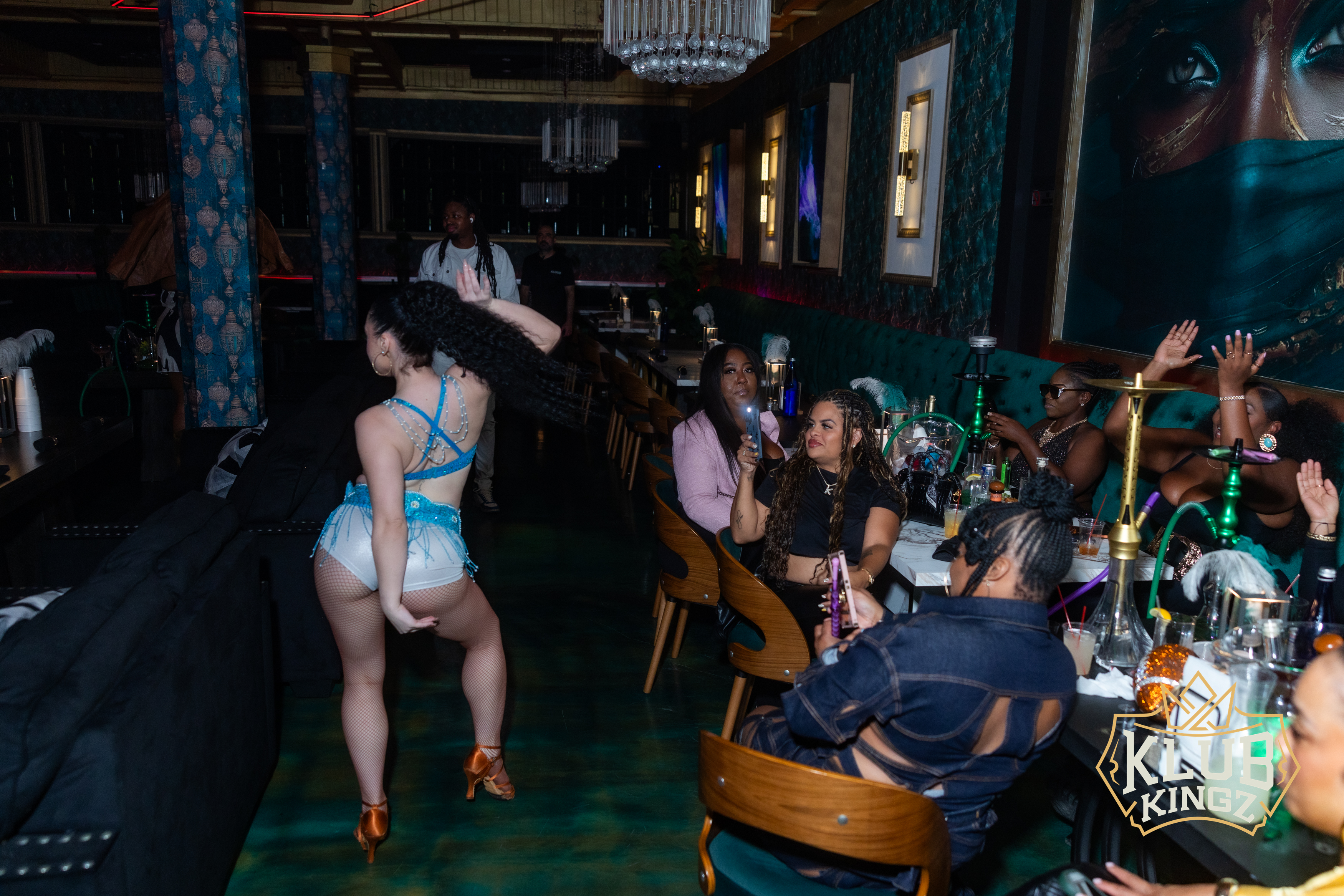 Dancer performing for guests at Klub Kingz nightclub with hookah lounge seating