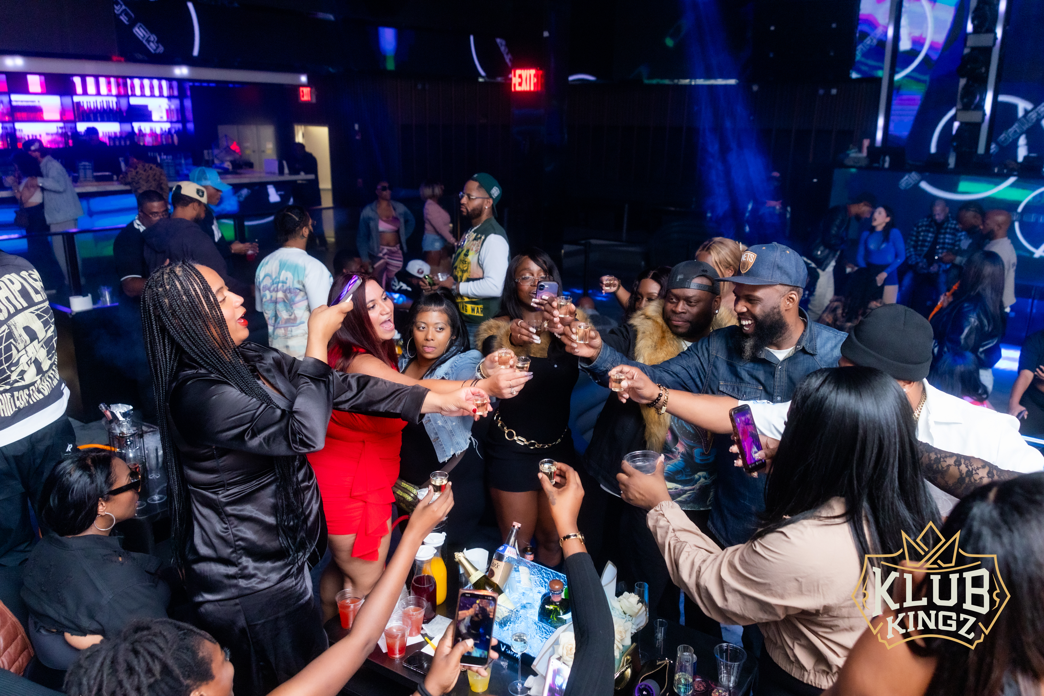 Group toasting with shots on the dance floor at Klub Kingz nightclub