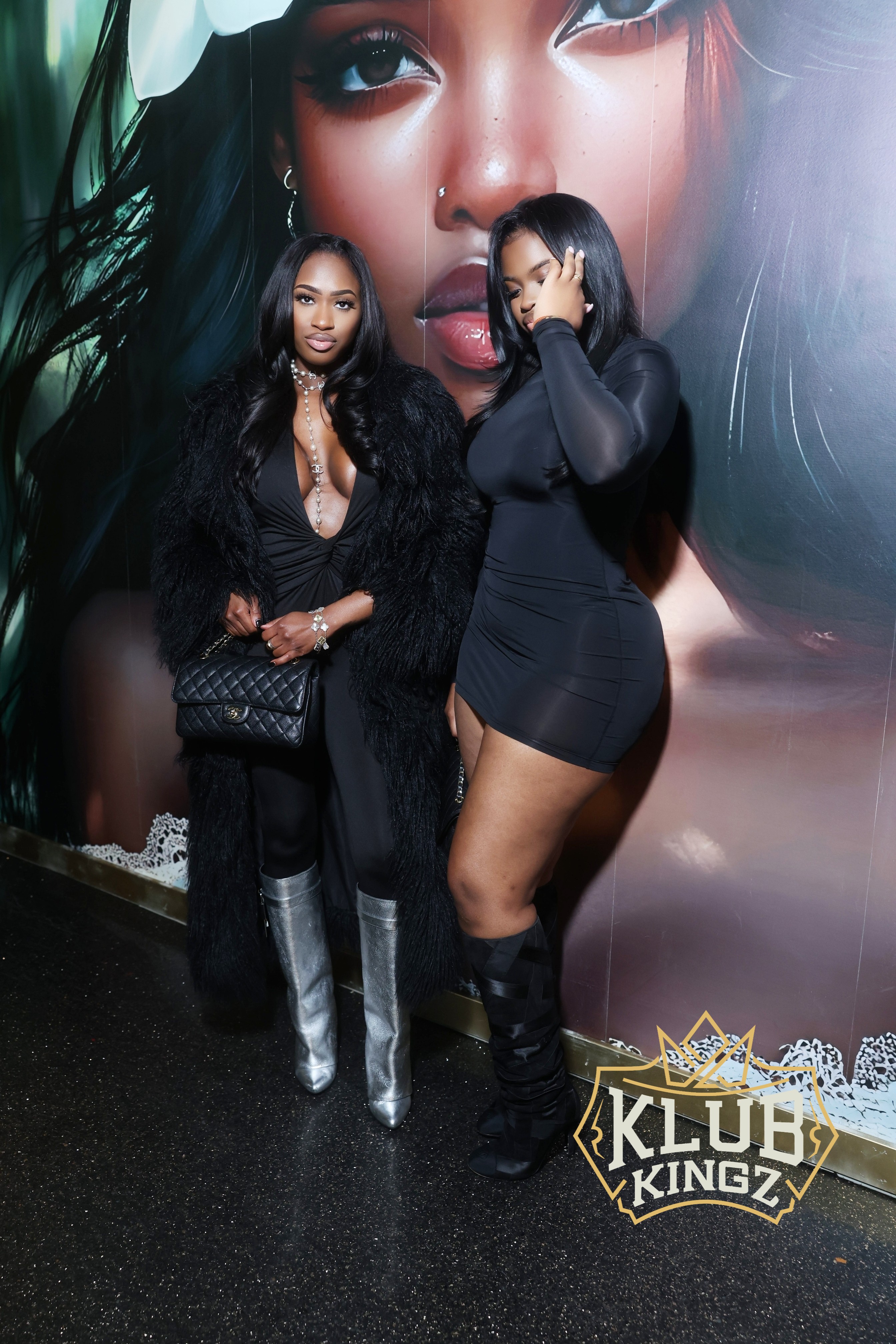 Two stylish women in black outfits pose at Klub Kingz nightclub event