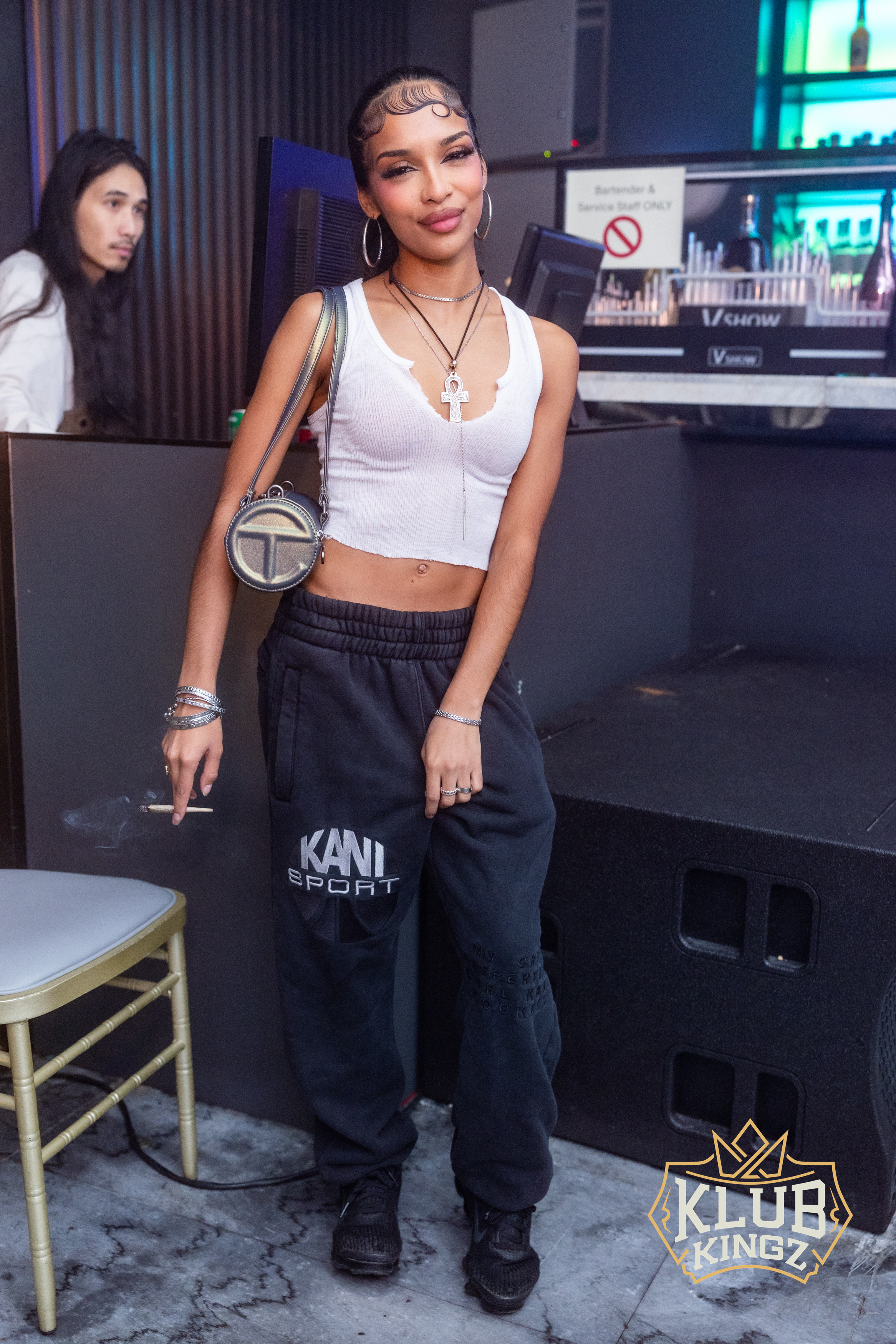 Stylish guest poses in crop top and Kani Sport joggers at Klub Kingz nightlife event.