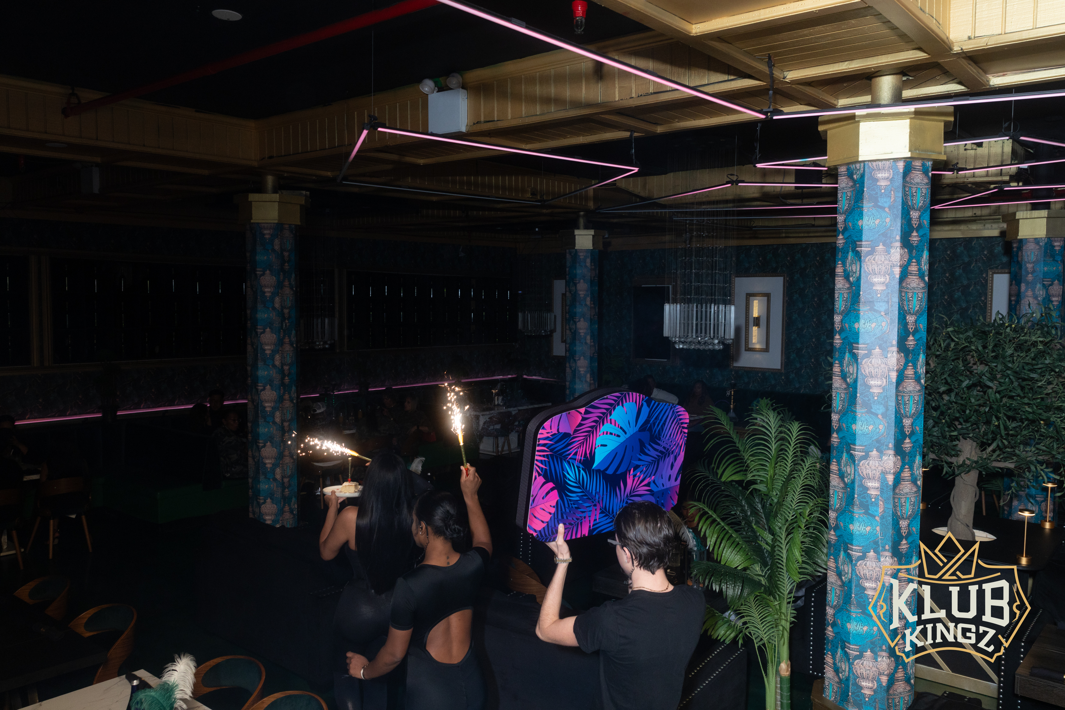 Guests holding sparklers during a birthday celebration at Klub Kingz nightclub