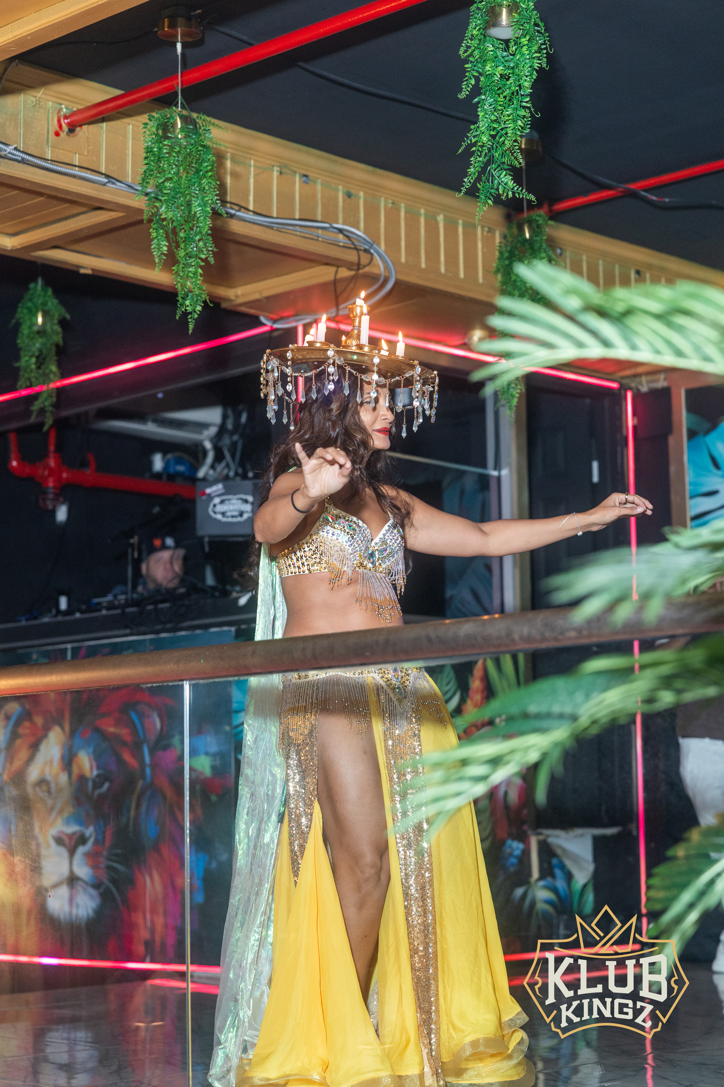 Belly dancer performing with candle crown headdress at Klub Kingz nightclub stage show