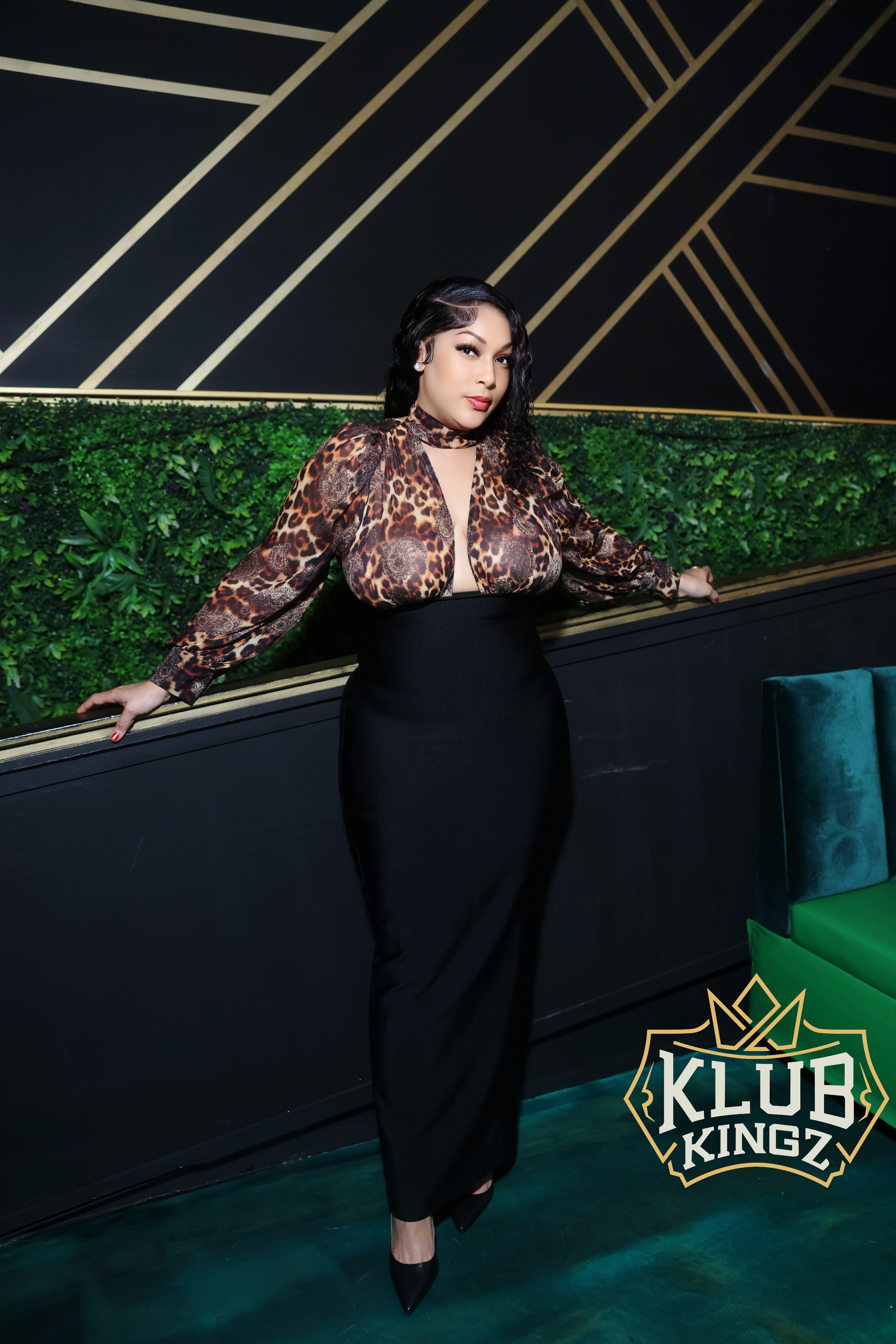 Woman in leopard-print top and black skirt posing at Klub Kingz nightclub event