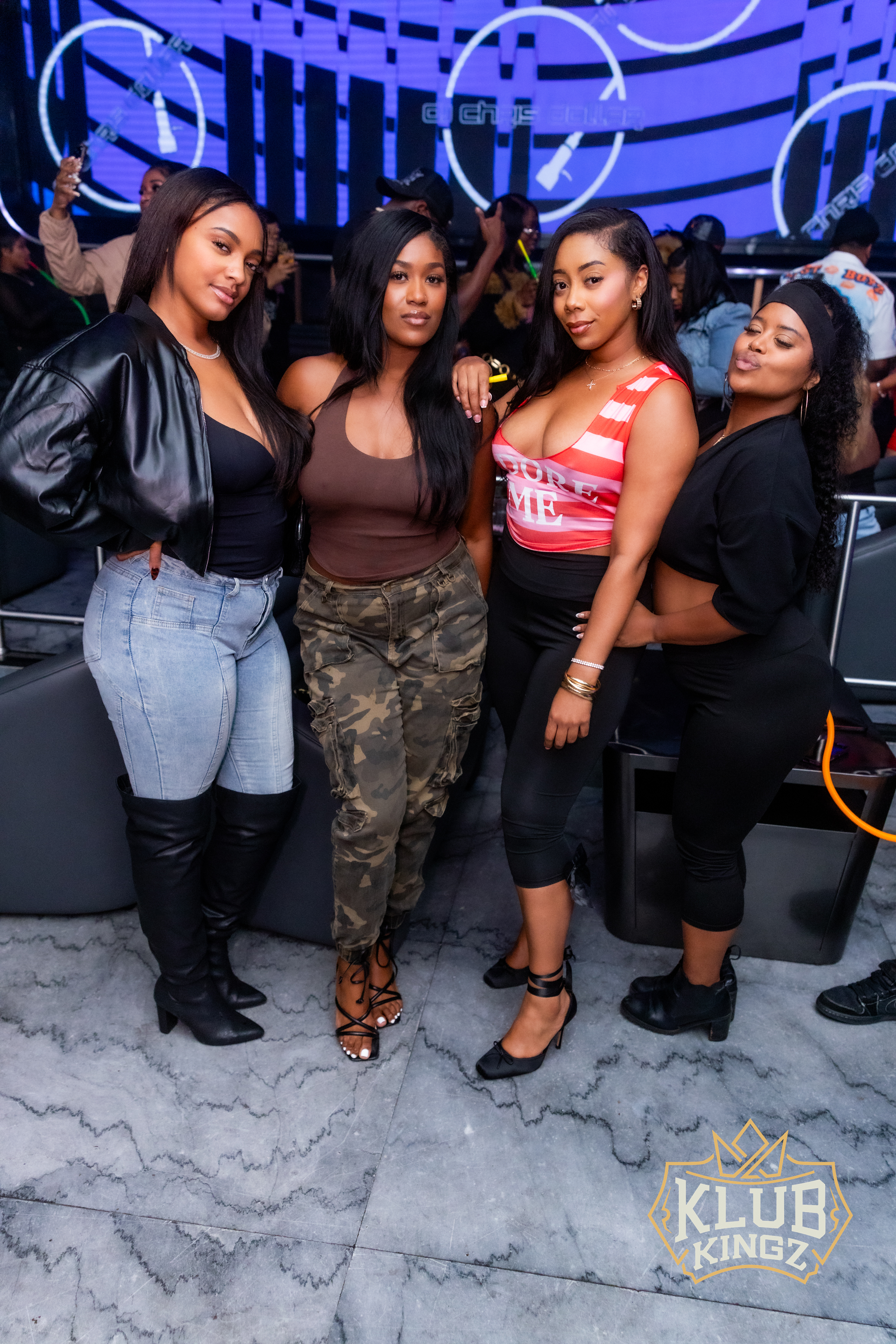 Four stylish women posing together on the dance floor at Klub Kingz nightclub