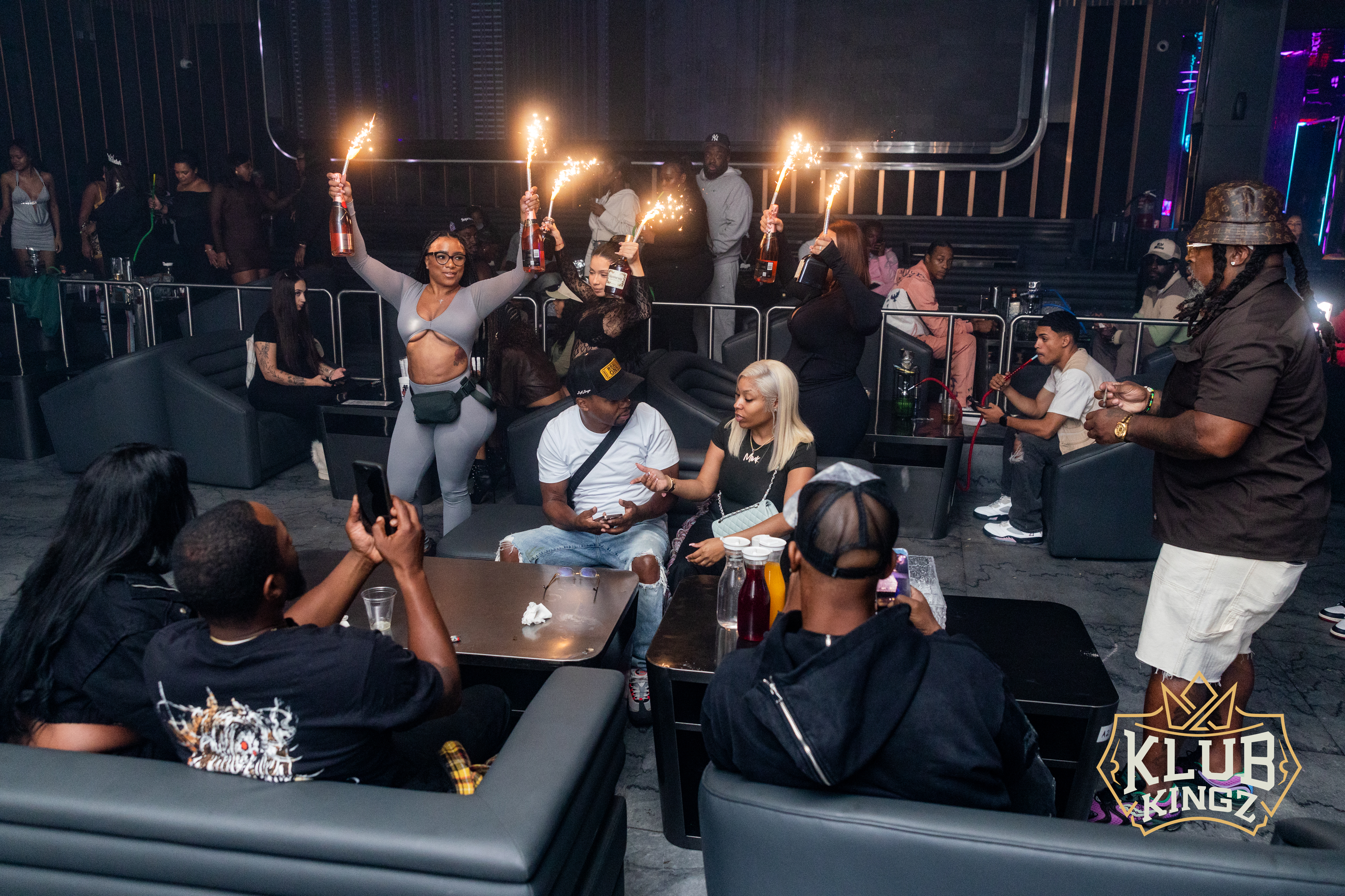 Guests celebrating with sparkler bottle service in VIP lounge seating at Klub Kingz nightclub