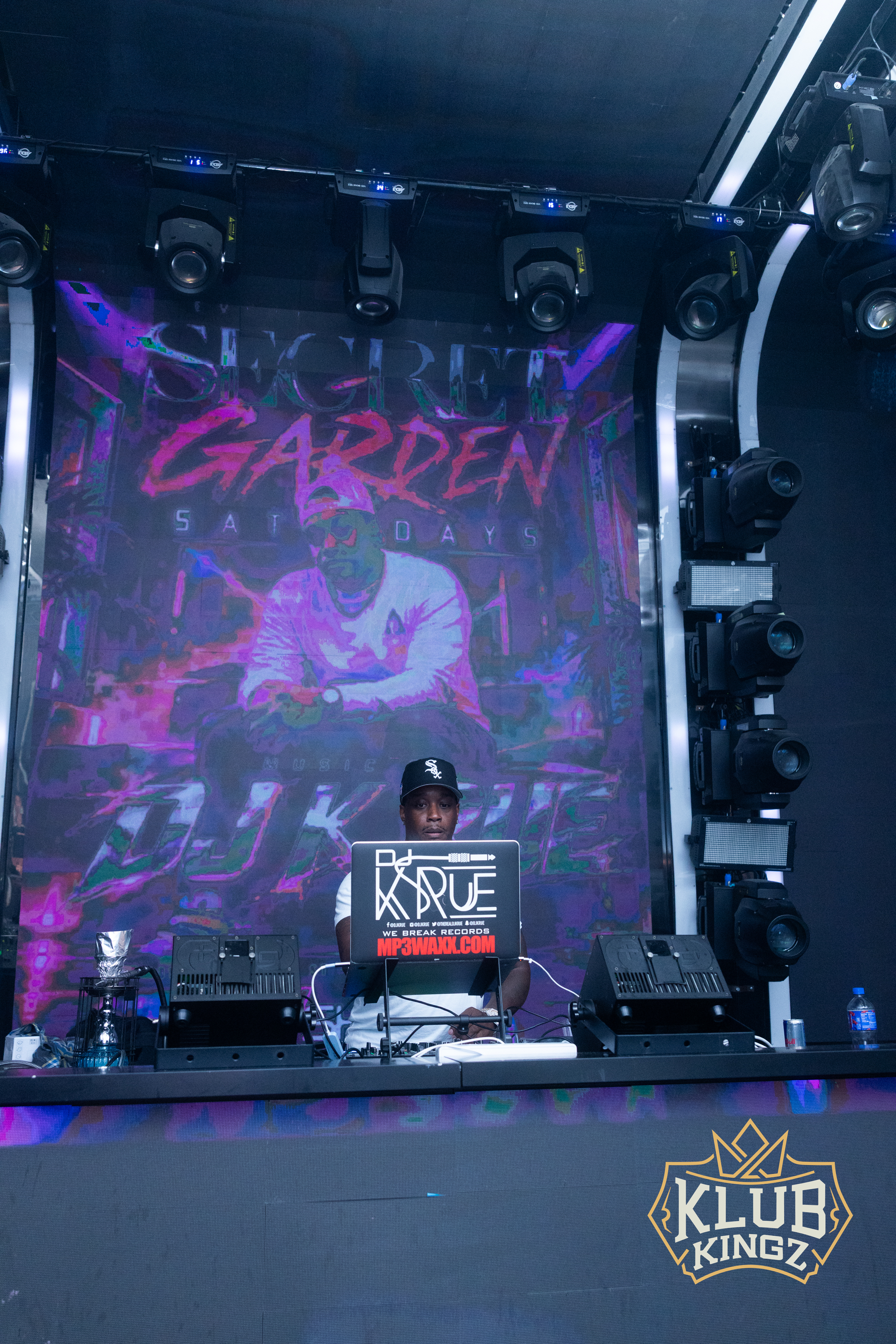 DJ performing at Klub Kingz Secret Garden Saturdays event with vibrant stage lighting and visuals.