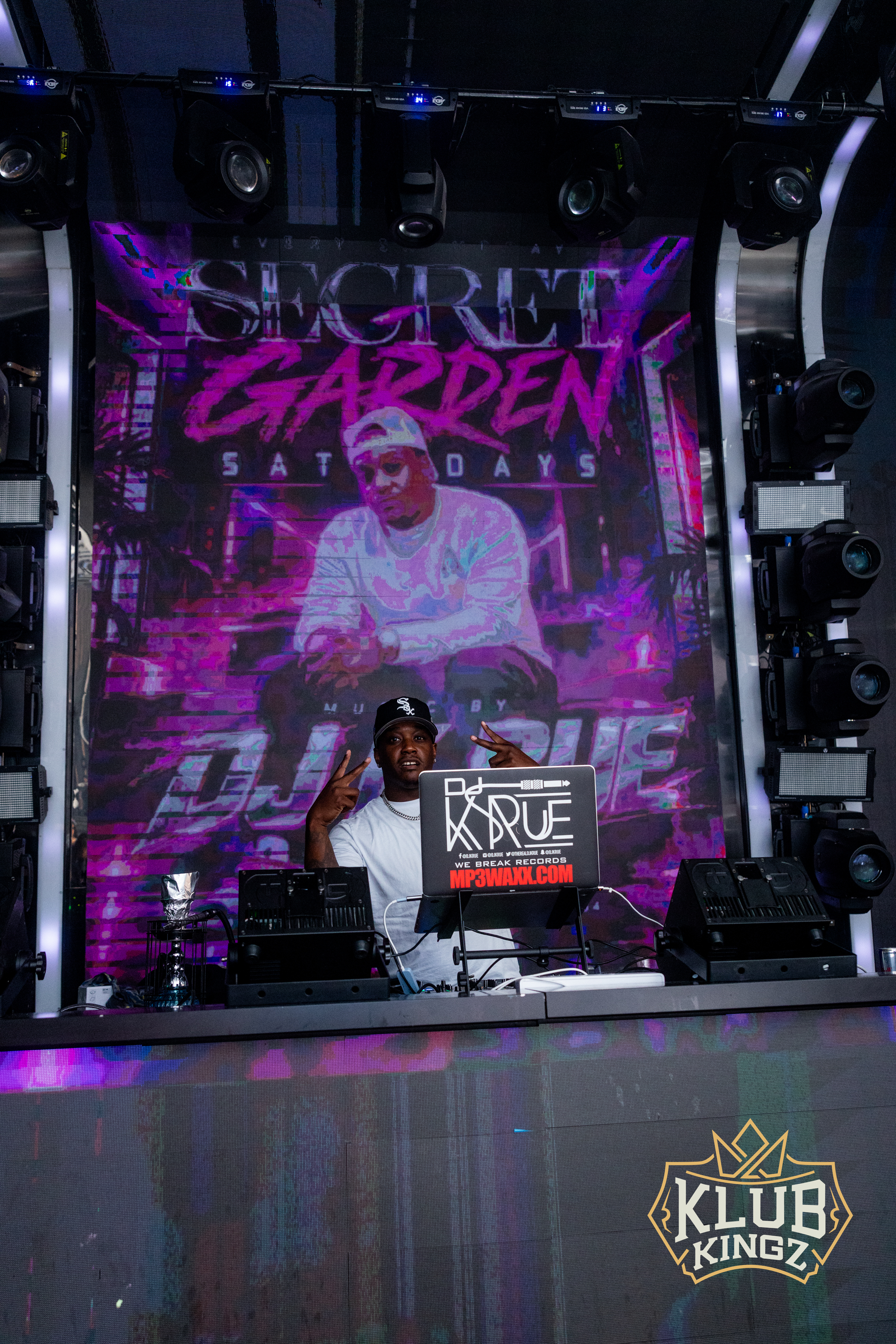 DJ performing at Klub Kingz Secret Garden Saturdays event with vibrant stage lighting