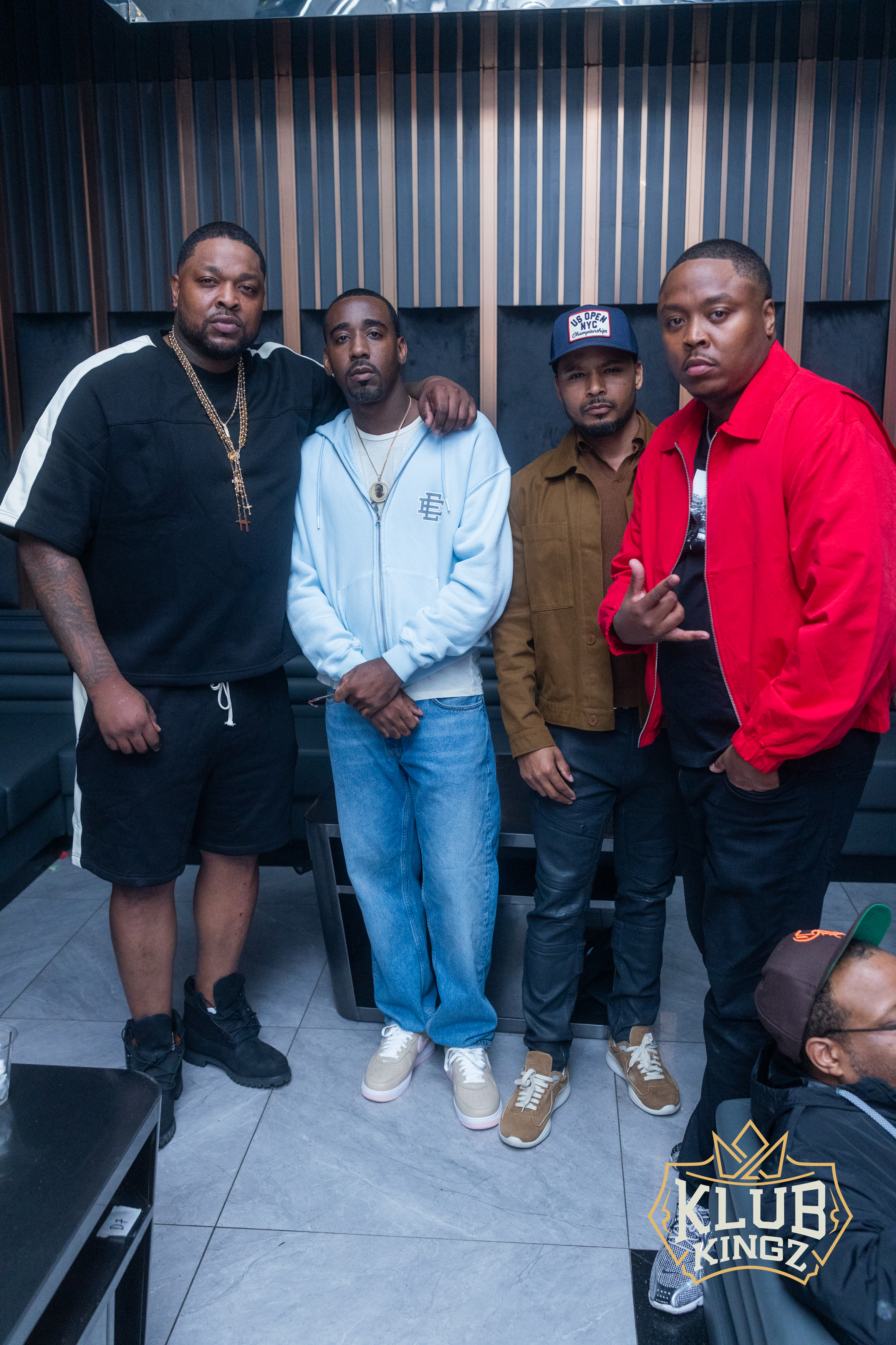 Four stylish men posing together in a VIP lounge at Klub Kingz nightclub