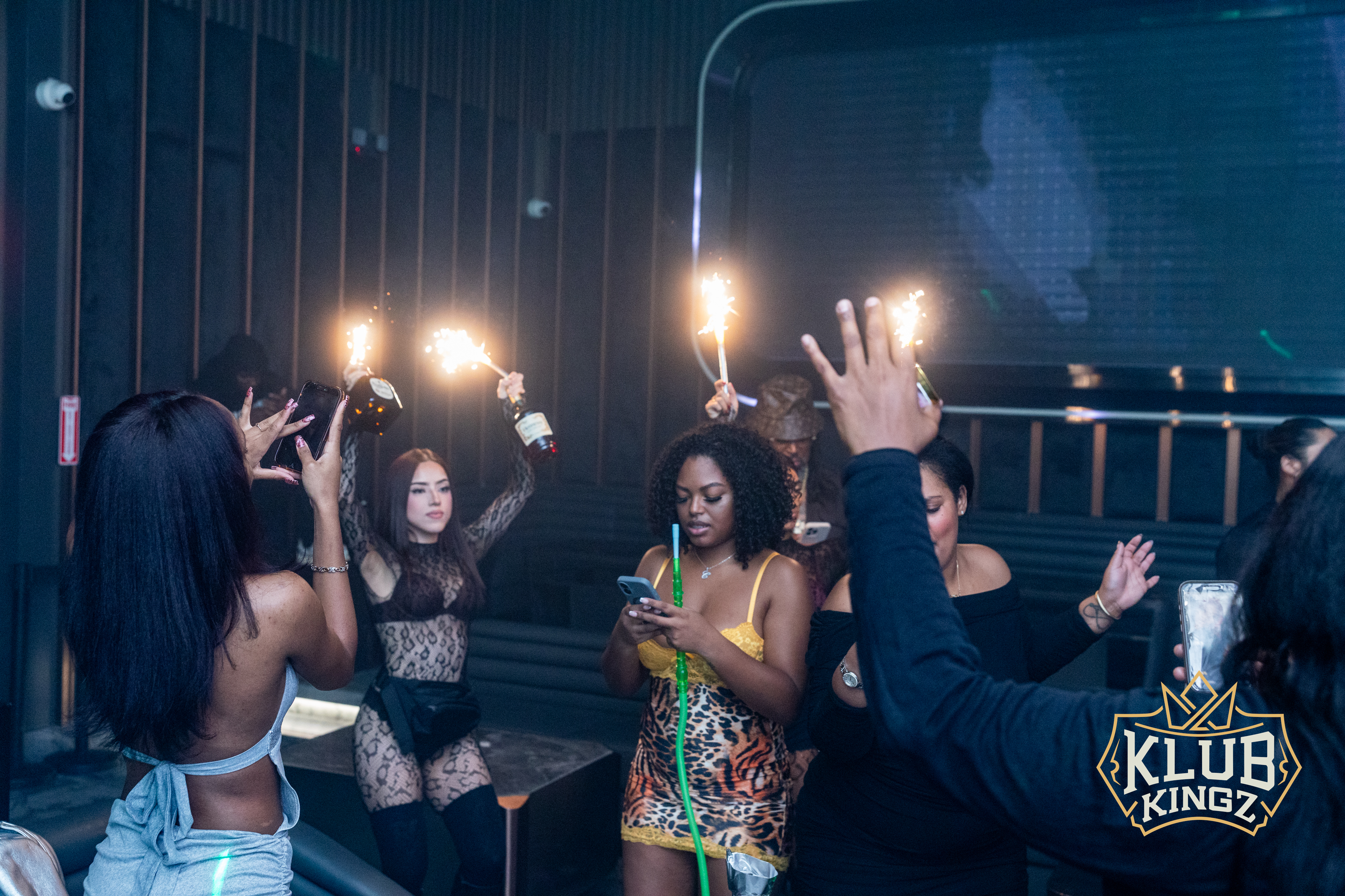 Guests celebrating with sparkler bottle service and hookah at Klub Kingz nightclub
