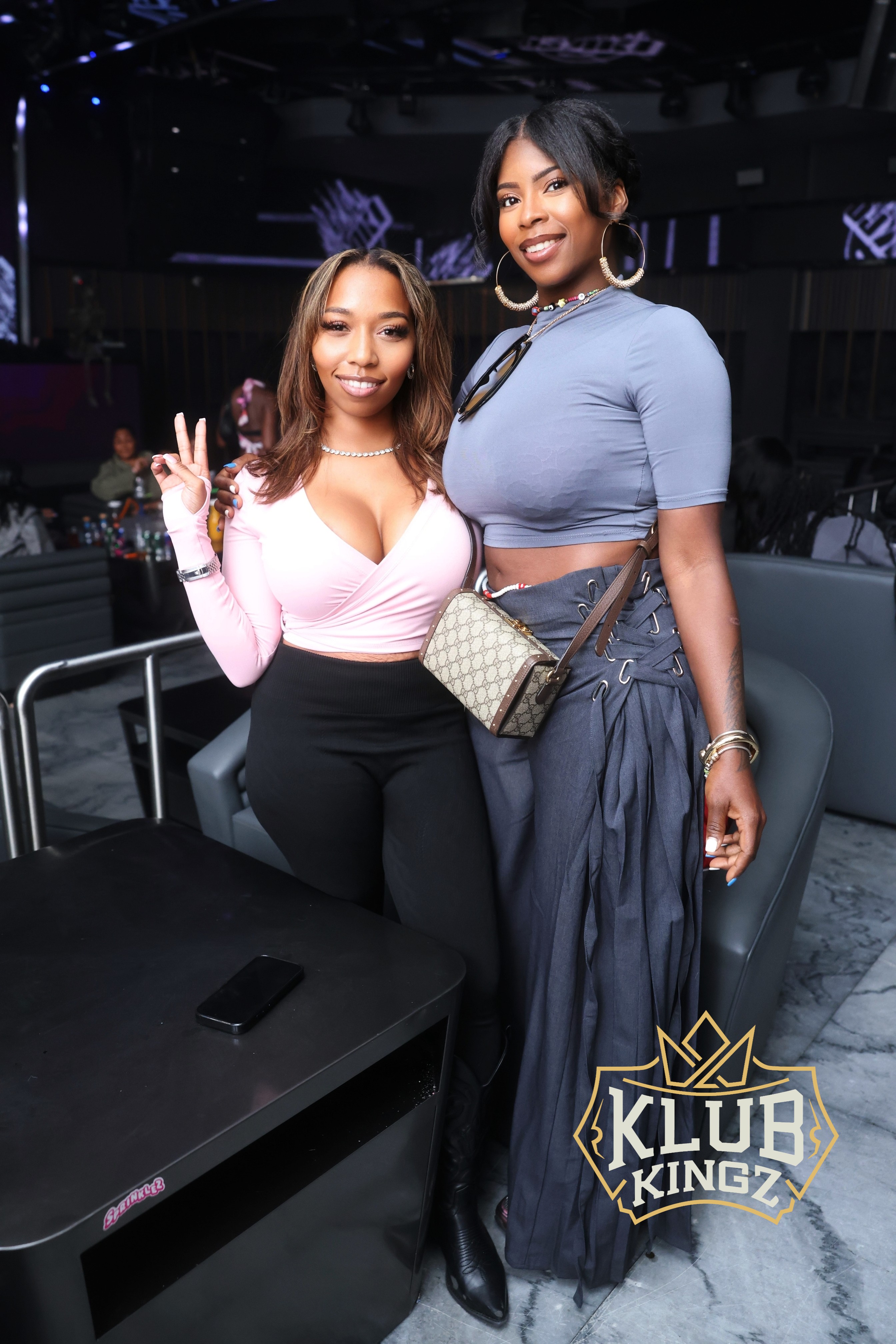 Two stylish women posing together at Klub Kingz nightclub, enjoying a night out