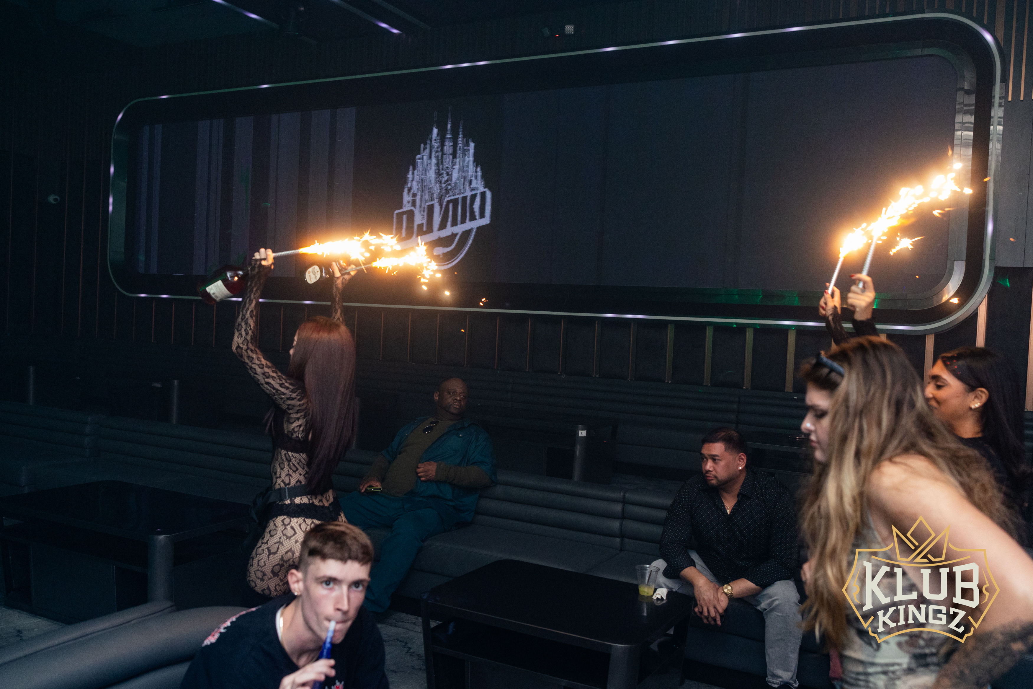 Guests holding sparklers over bottle service in VIP lounge at Klub Kingz nightclub