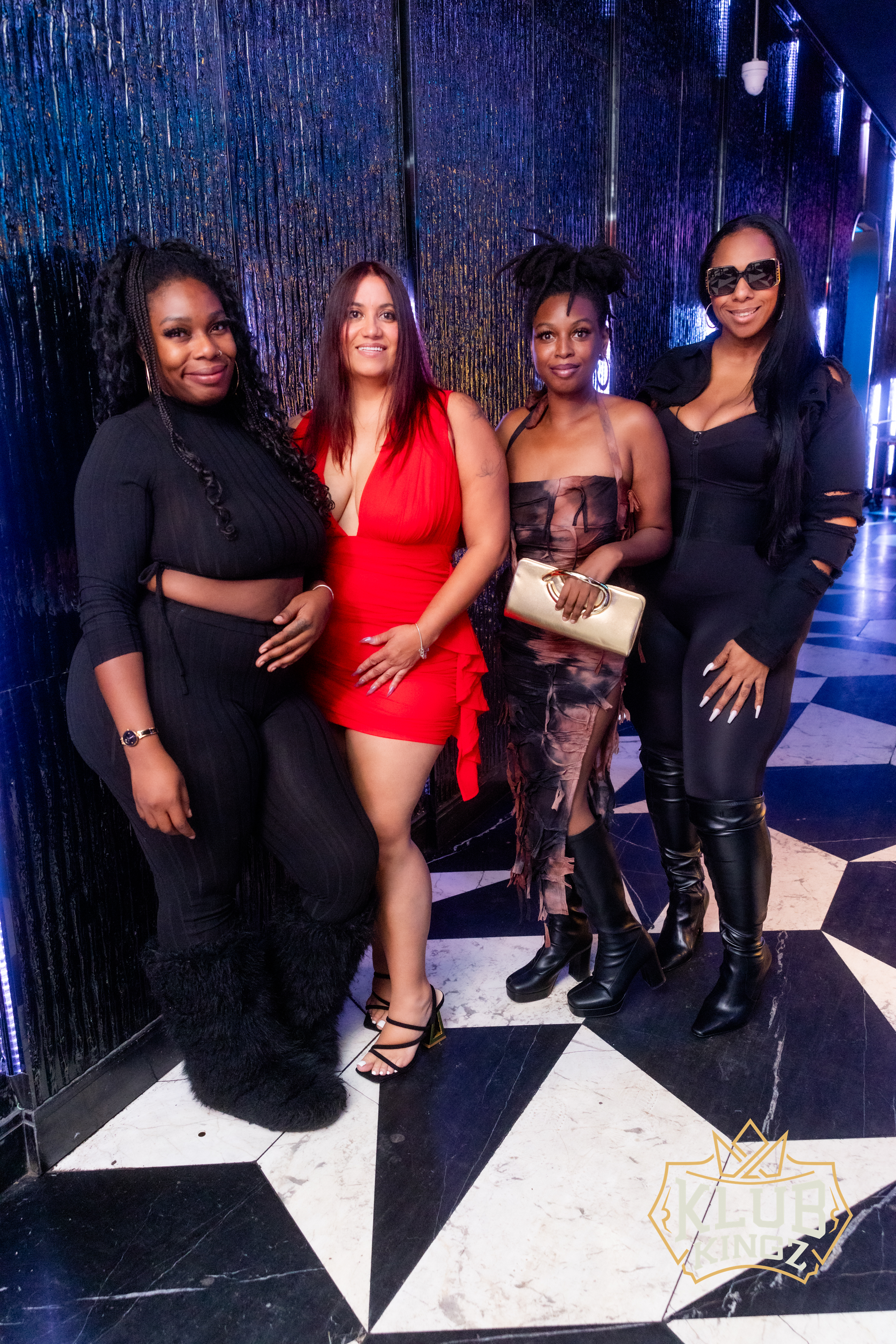 Four stylishly dressed women posing together at Klub Kingz nightclub event