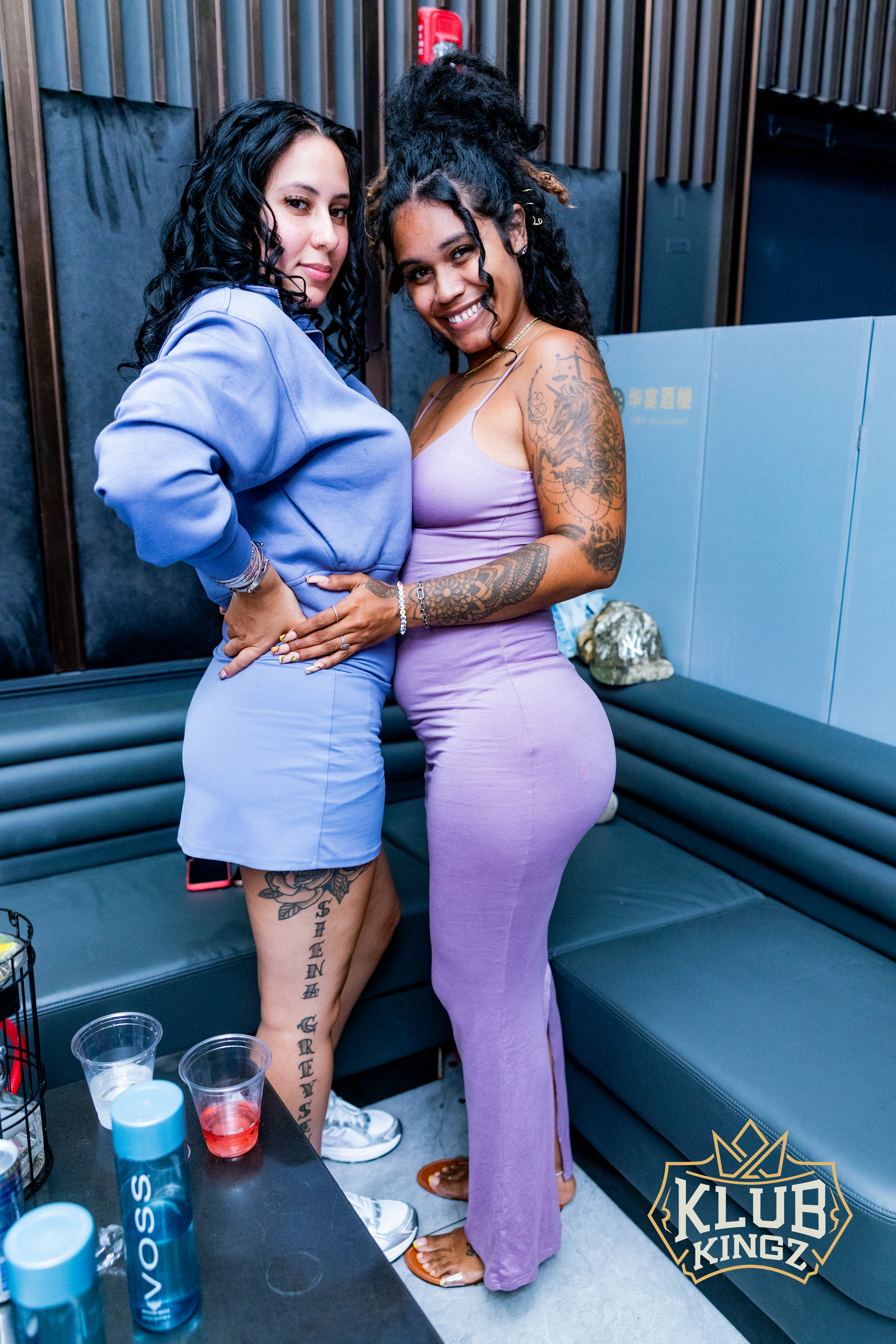 Two stylish women posing together in VIP booth at Klub Kingz nightclub event