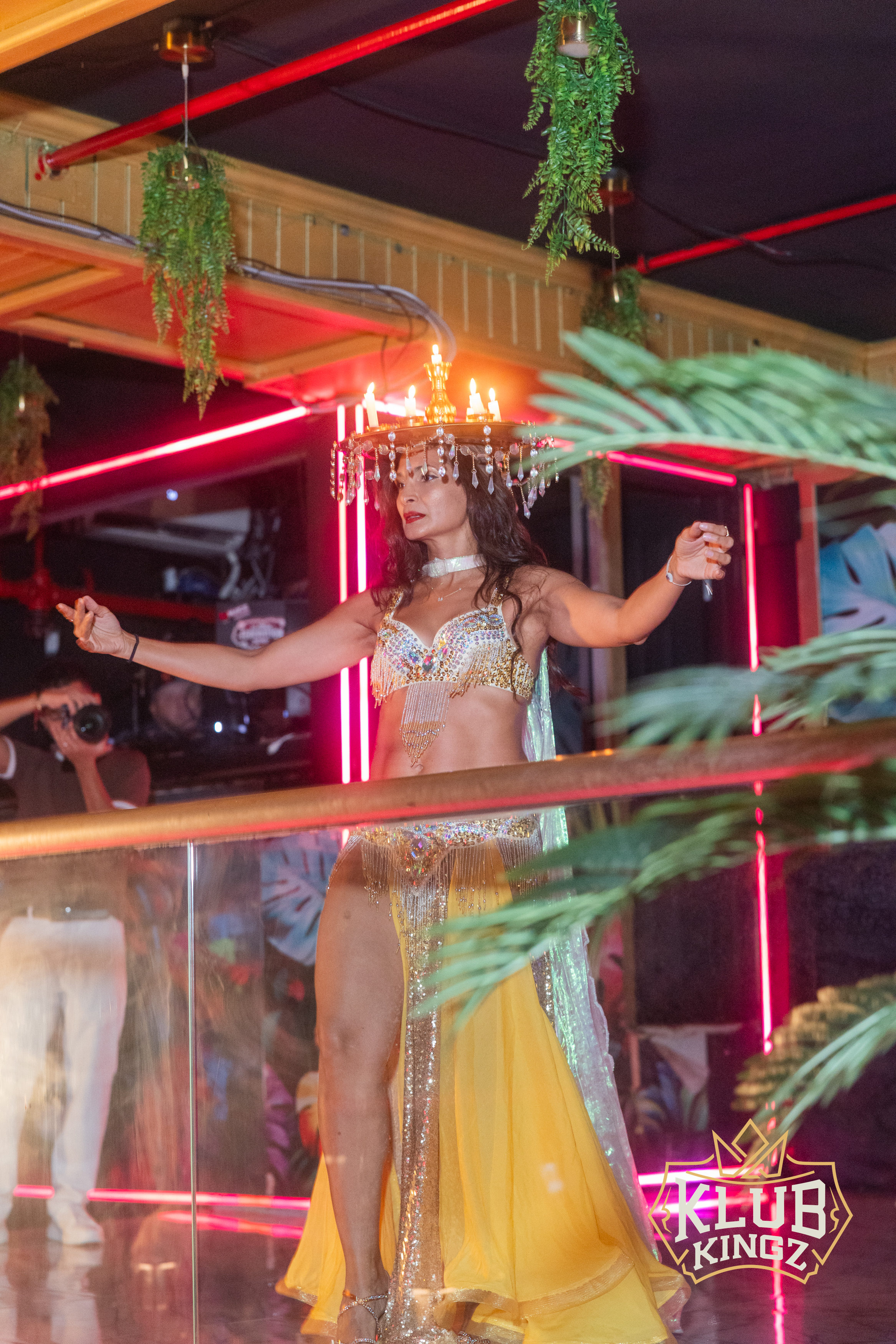 Belly dancer in candle headdress performs on stage at Klub Kingz nightclub event