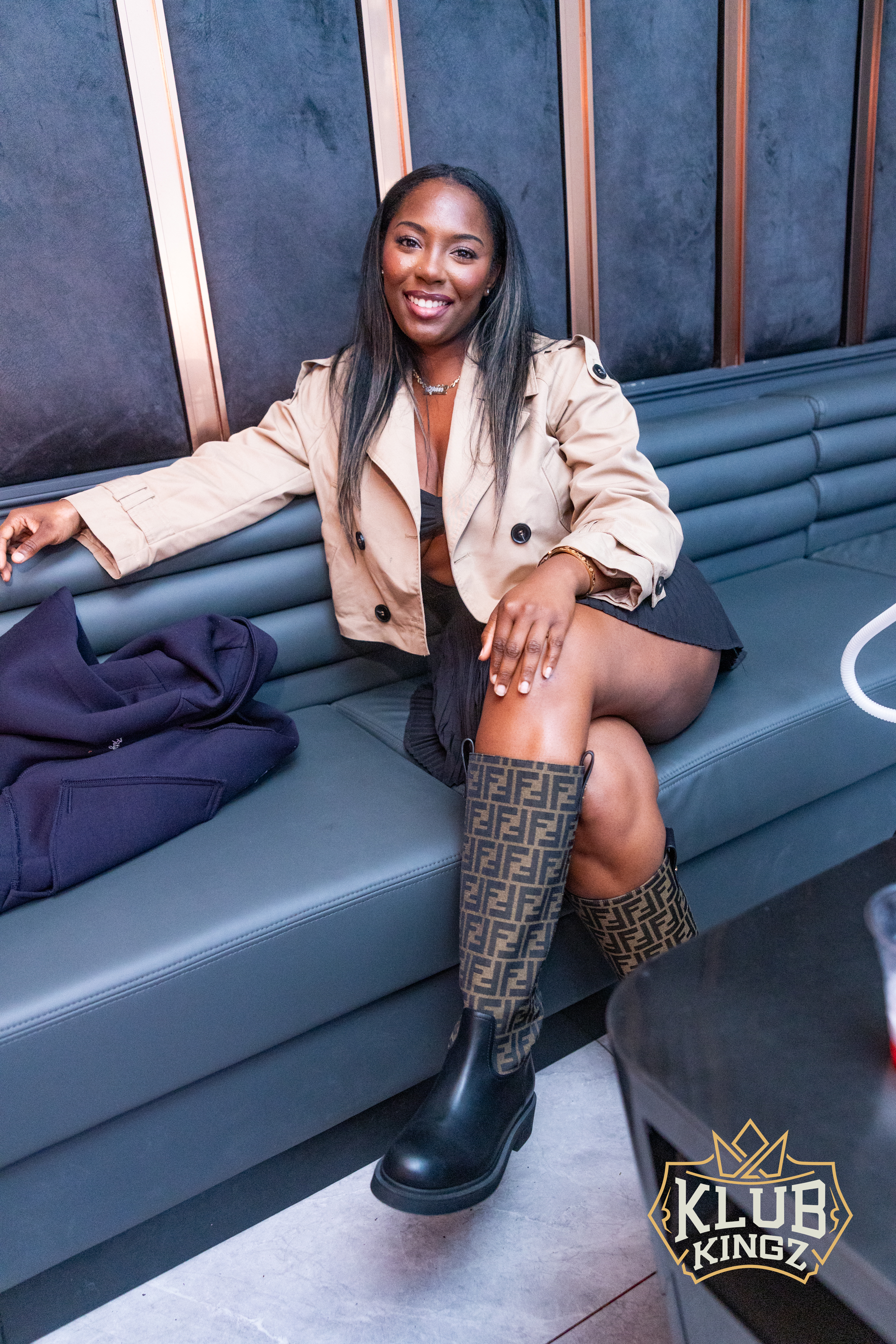 Stylish guest smiling on lounge seating at Klub Kingz nightclub VIP area