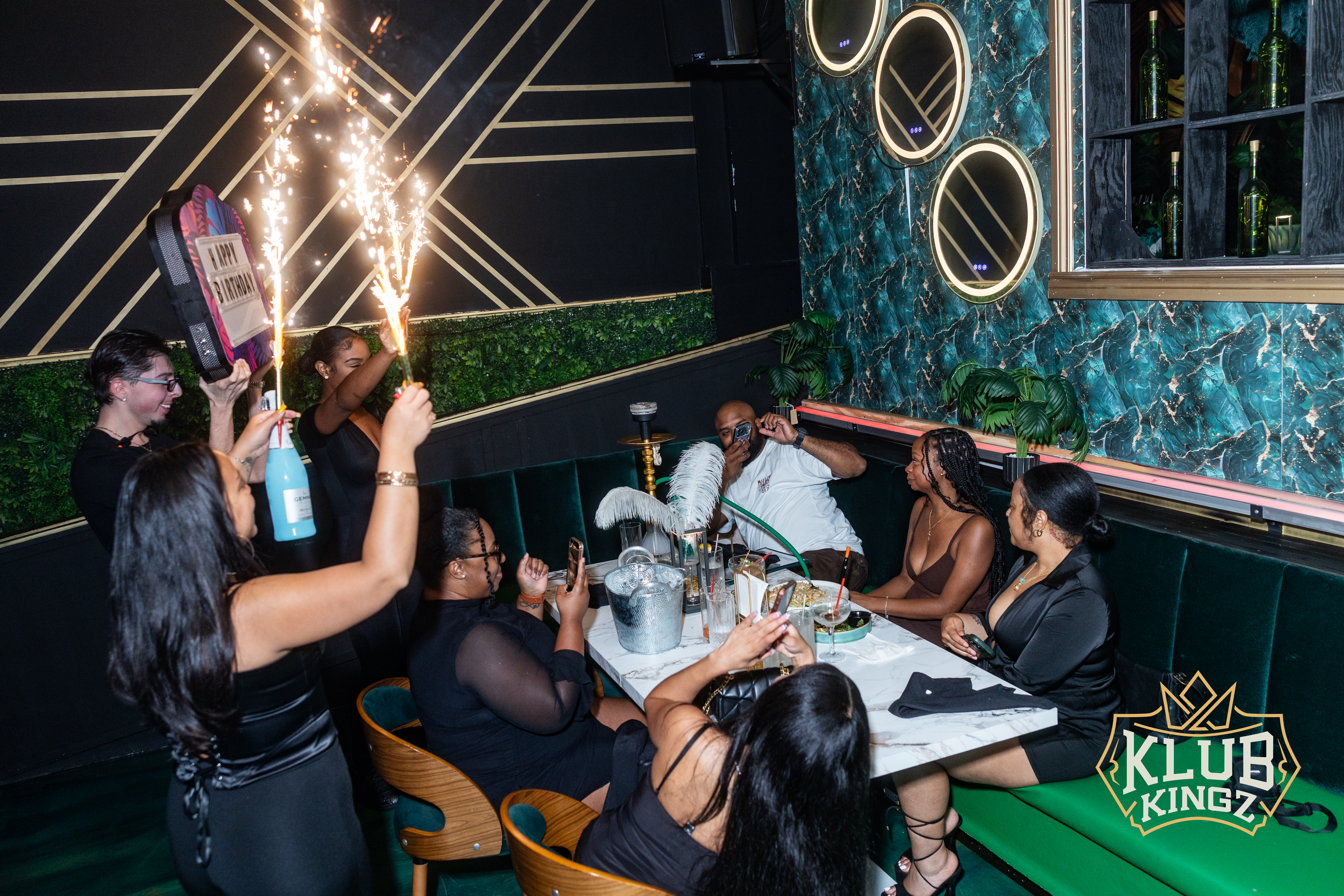 Birthday celebration with sparkler bottles and hookah at Klub Kingz lounge booth seating