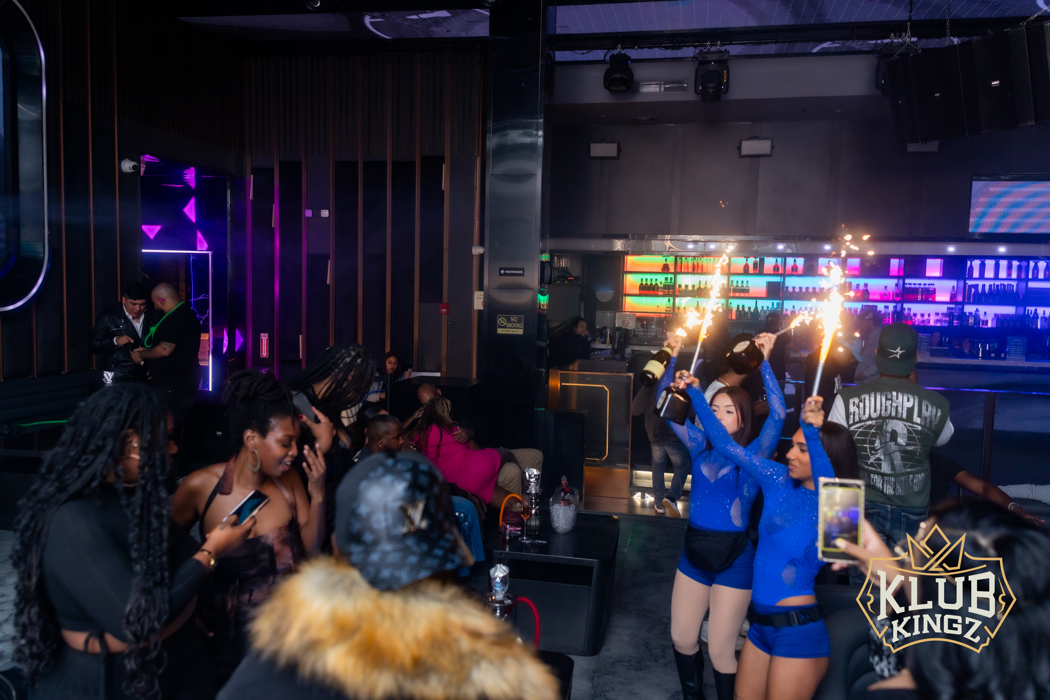 Dancers hold sparkler bottle service during a lively night at Klub Kingz nightclub