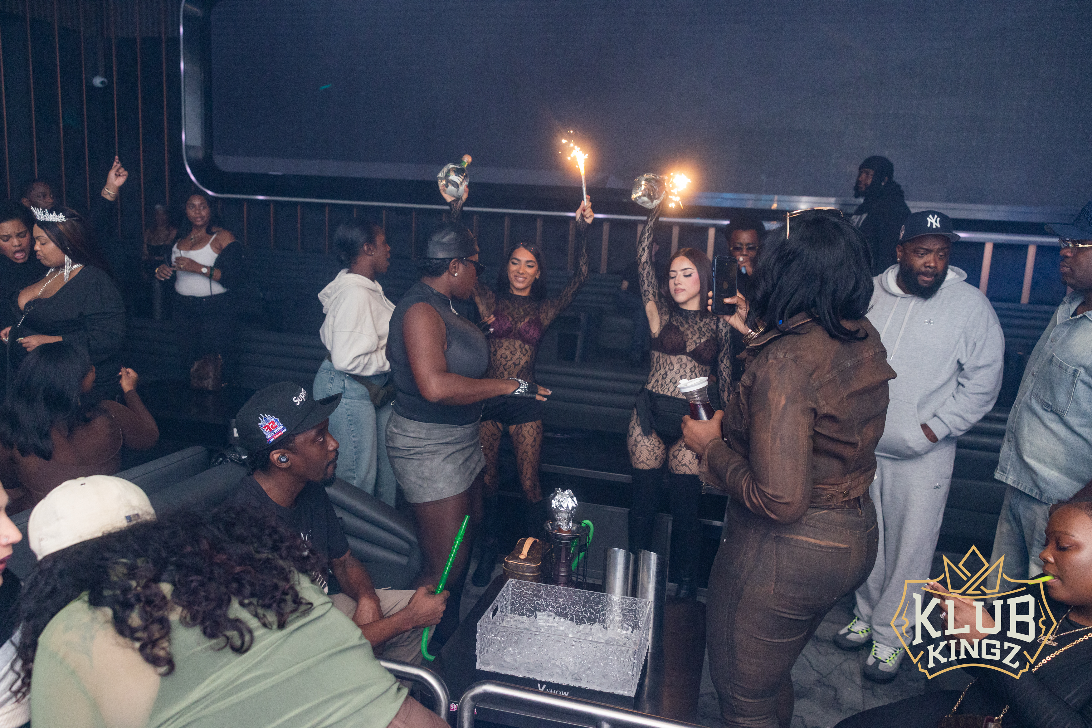 Nightclub crowd celebrating with sparkler bottle service at Klub Kingz VIP table