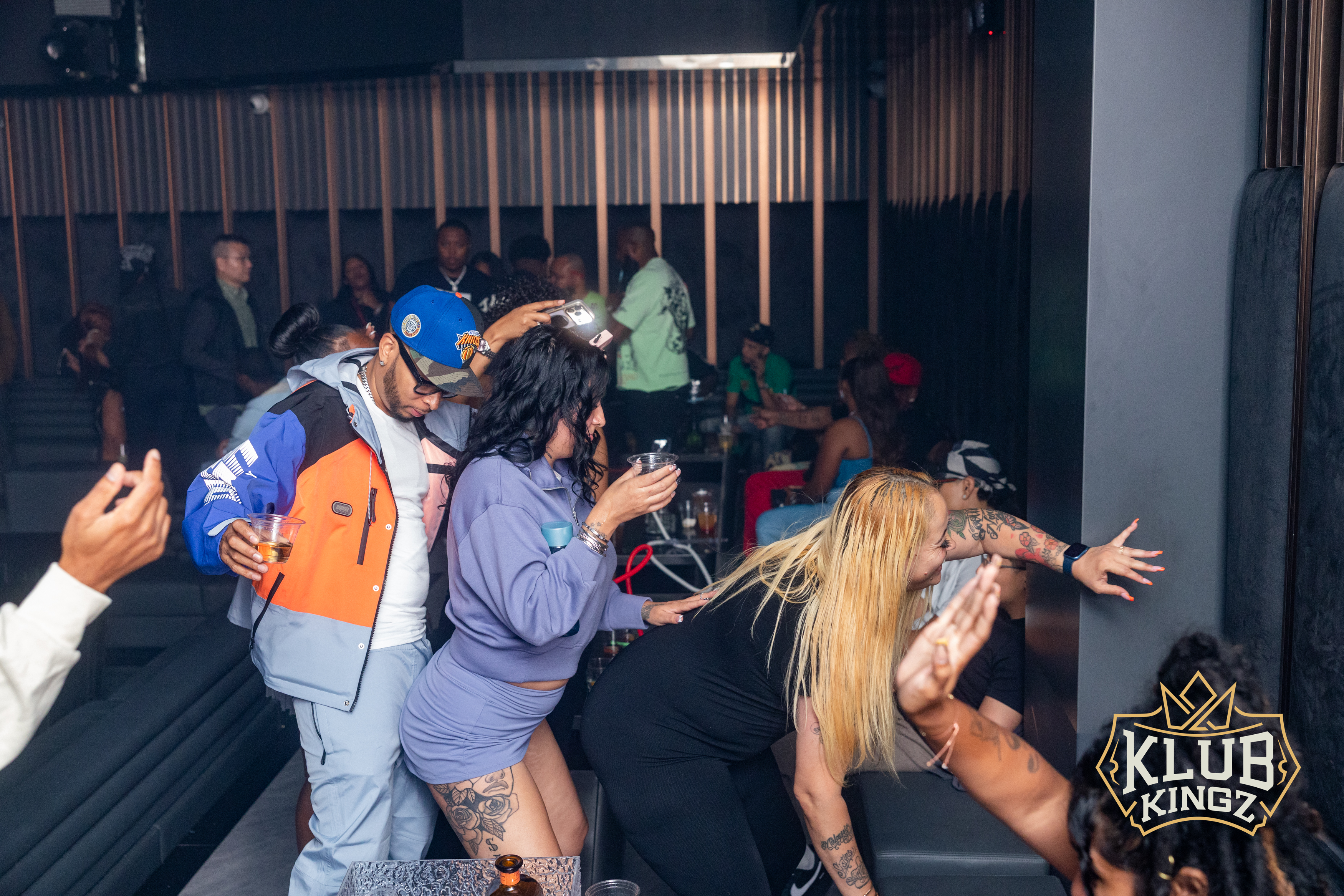 Crowd dancing and drinking at Klub Kingz nightclub with vibrant lighting and lively nightlife atmosphere