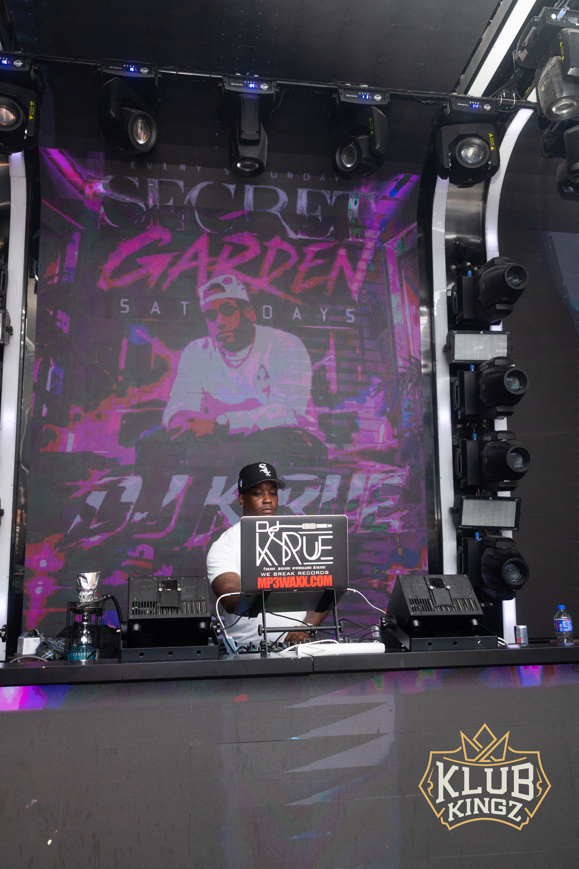 DJ K-Rue performing at Secret Garden Saturdays, Klub Kingz nightclub stage with vibrant LED backdrop