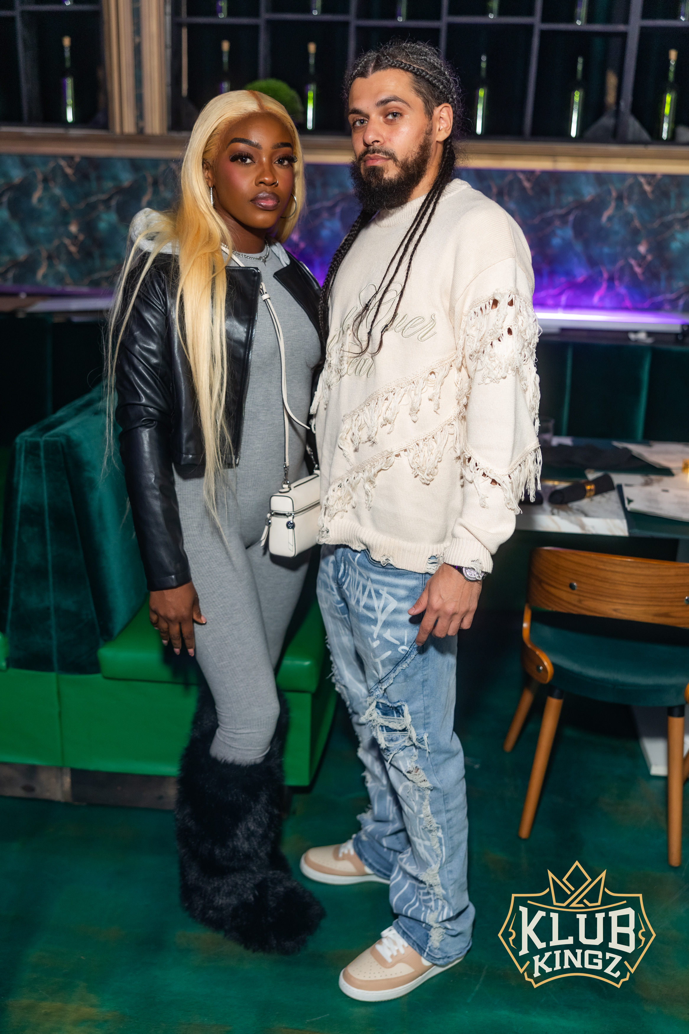 Stylish couple posing together at Klub Kingz nightclub event